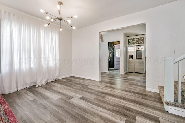 1033 Bowie St, Amarillo, TX 79102 - empty room with a chandelier, stairs, wood finished floors, and baseboards
