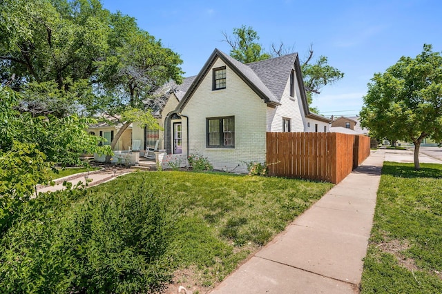 1033 Bowie St, Amarillo, TX 79102 - tudor house featuring brick siding and a shingled roof