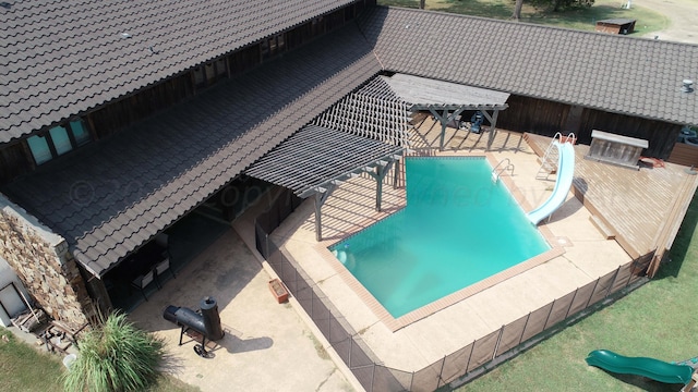 view of pool featuring a patio area and a water slide