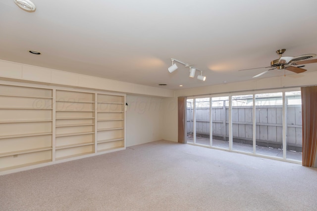 carpeted spare room featuring a ceiling fan and rail lighting