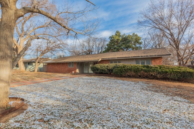 ranch-style house featuring brick siding and driveway