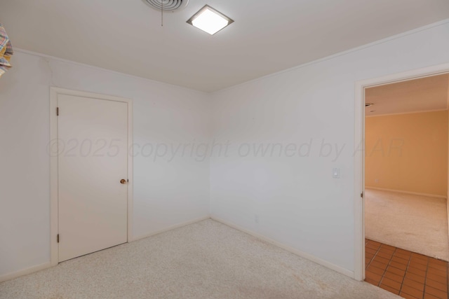 empty room featuring baseboards and carpet flooring