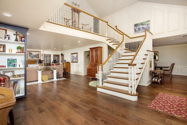 4214 Roxton Dr, Amarillo, TX 79109 - staircase featuring a decorative wall, wood finished floors, recessed lighting, a towering ceiling, and crown molding