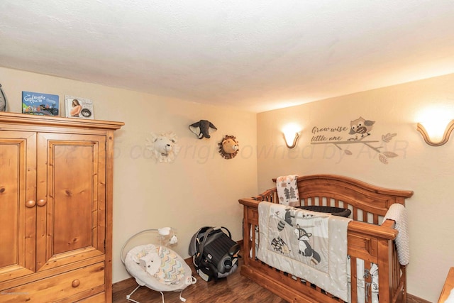 830 Burnett St, Miami, TX 79059 - bedroom with wood finished floors and a crib