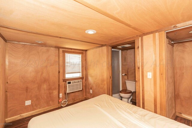 830 Burnett St, Miami, TX 79059 - bedroom featuring wood ceiling, connected bathroom, cooling unit, and wooden walls