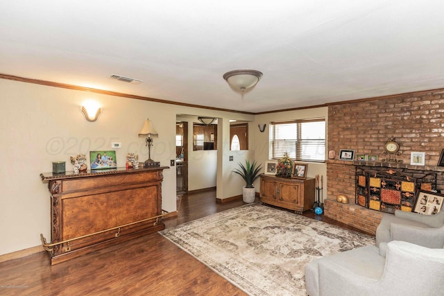 830 Burnett St, Miami, TX 79059 - living room featuring ornamental molding, dark wood-type flooring, baseboards, visible vents, and a fireplace