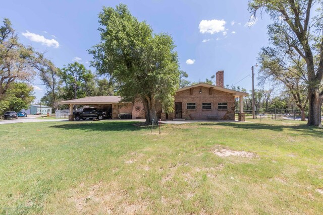 830 Burnett St, Miami, TX 79059 - view of yard with an attached carport and fence