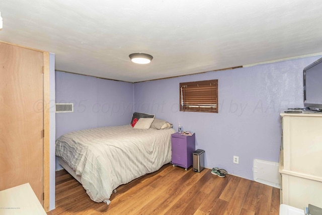 830 Burnett St, Miami, TX 79059 - bedroom featuring visible vents and wood finished floors