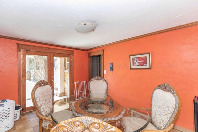 830 Burnett St, Miami, TX 79059 - dining area with stone finish floor, baseboards, a textured wall, and ornamental molding