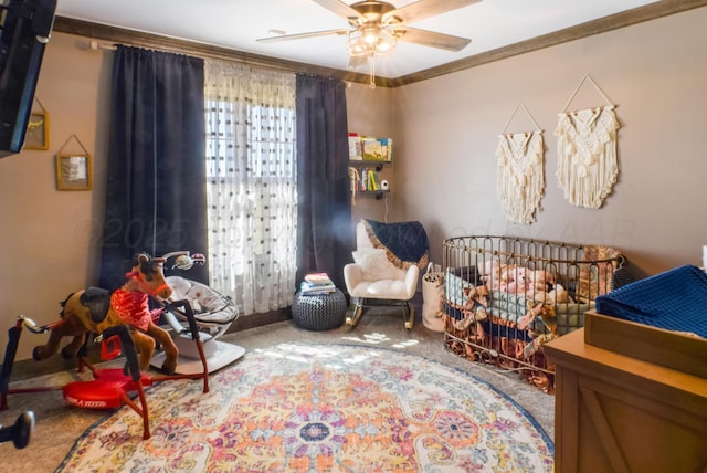 carpeted bedroom featuring ornamental molding and a ceiling fan