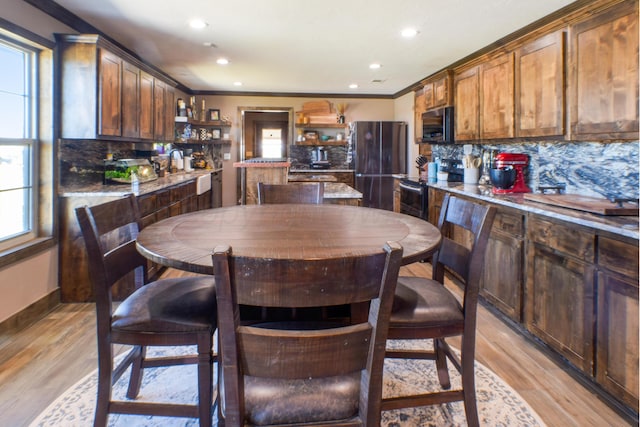 kitchen with open shelves, black / electric stove, freestanding refrigerator, and tasteful backsplash