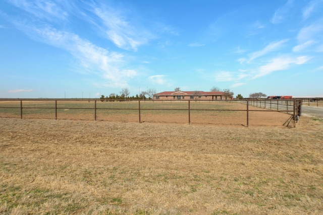 view of yard with a rural view and fence