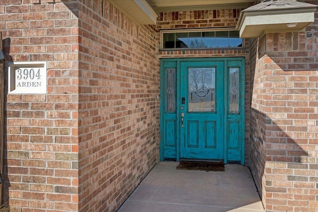 doorway to property with brick siding