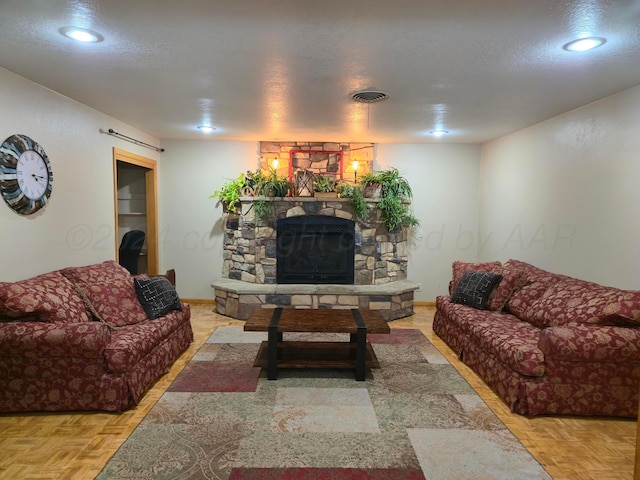 living room with a stone fireplace