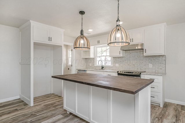 6011 Palmetto Trl, Amarillo, TX 79106 - kitchen with butcher block countertops, under cabinet range hood, stainless steel electric range, and a sink
