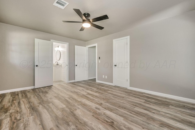 6011 Palmetto Trl, Amarillo, TX 79106 - unfurnished bedroom with wood finished floors, baseboards, and ceiling fan