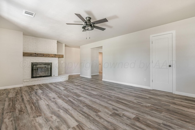 6011 Palmetto Trl, Amarillo, TX 79106 - unfurnished living room with wood finished floors, ceiling fan, baseboards, and a fireplace