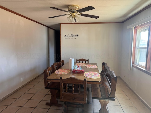 dining room with baseboards, ornamental molding, a ceiling fan, and tile patterned floors