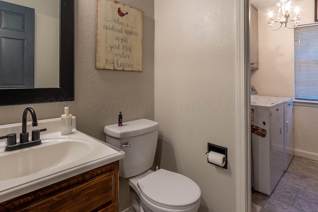 bathroom featuring toilet, an inviting chandelier, vanity, and independent washer and dryer