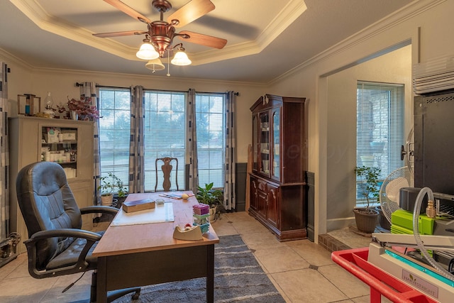 office space featuring ceiling fan, crown molding, a tray ceiling, and light tile patterned floors