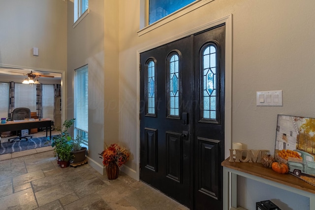 foyer entrance with ceiling fan