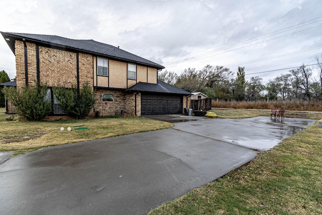 view of side of property with a lawn and a garage