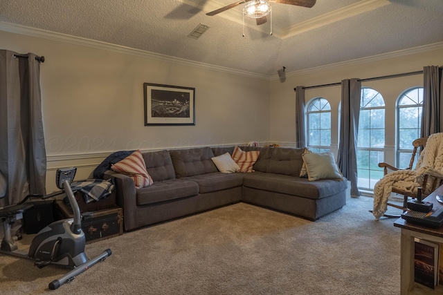 carpeted living room featuring a textured ceiling, ceiling fan, and crown molding