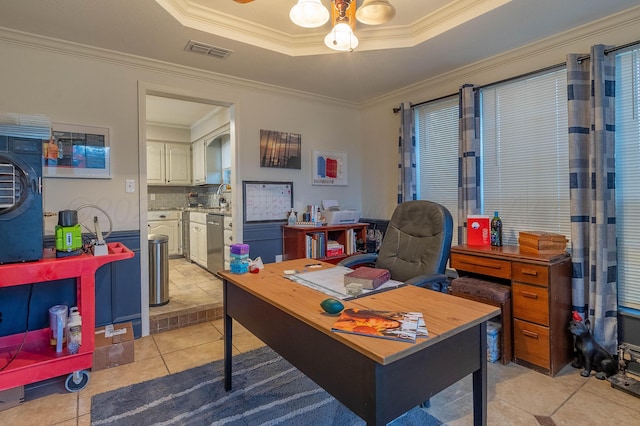 tiled home office featuring a tray ceiling, sink, and crown molding