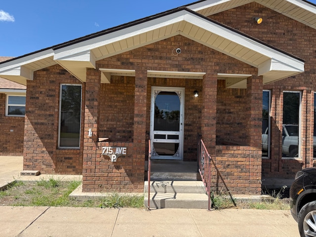715 Ave P, Sunray, TX 79086 - entrance to property featuring brick siding and a porch