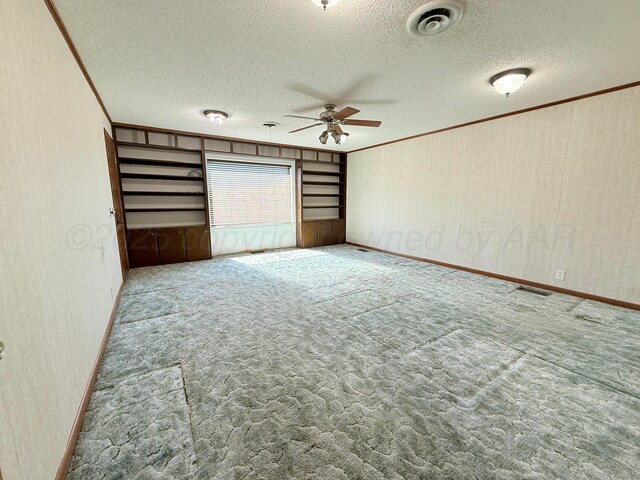 715 Ave P, Sunray, TX 79086 - unfurnished room with ceiling fan, ornamental molding, carpet floors, a textured ceiling, and baseboards