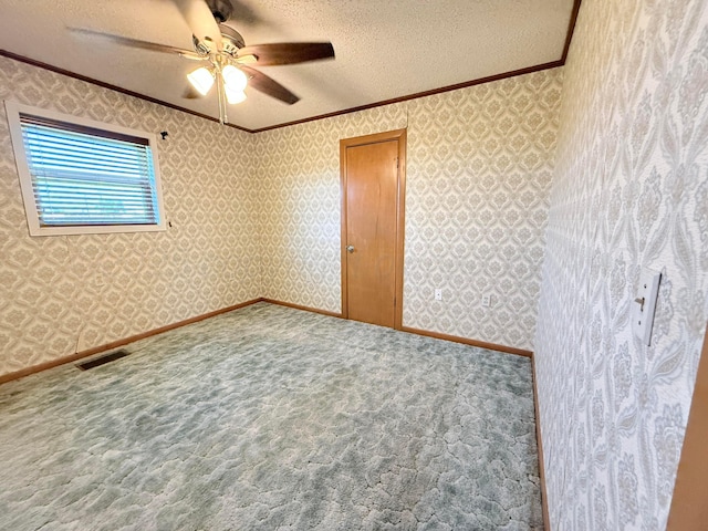 715 Ave P, Sunray, TX 79086 - spare room featuring ornamental molding, ceiling fan, a textured ceiling, carpet flooring, and wallpapered walls