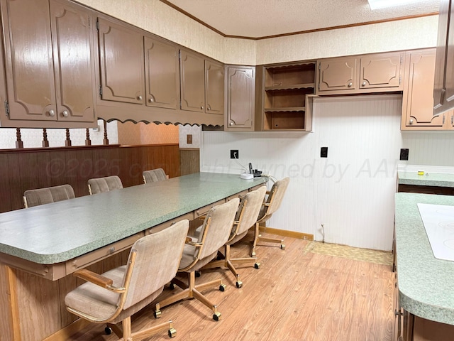 715 Ave P, Sunray, TX 79086 - home office with light wood-style flooring, baseboards, crown molding, and a textured ceiling