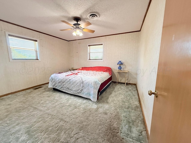 715 Ave P, Sunray, TX 79086 - carpeted bedroom featuring ornamental molding, baseboards, a textured ceiling, and ceiling fan