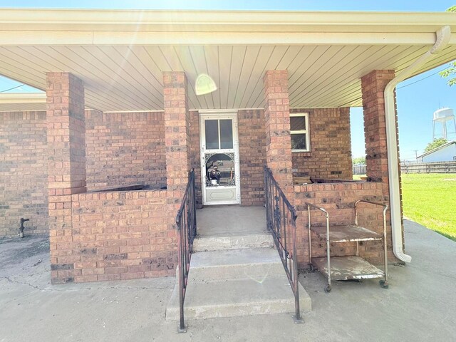715 Ave P, Sunray, TX 79086 - entrance to property with a porch and brick siding