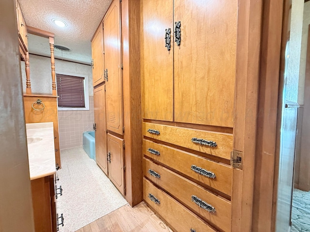 715 Ave P, Sunray, TX 79086 - detailed view of a textured ceiling, wood finished floors, and tile walls