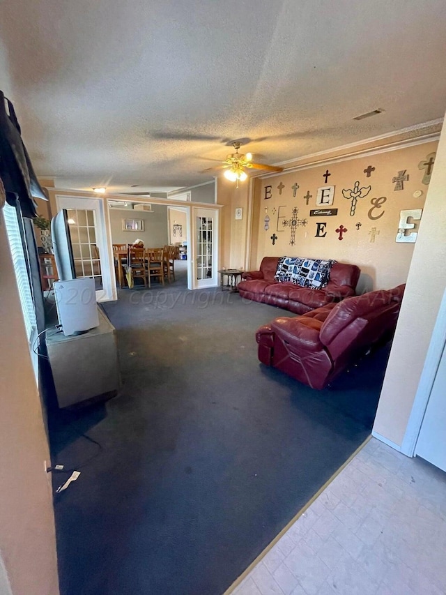 living room featuring french doors, ceiling fan, a textured ceiling, and crown molding