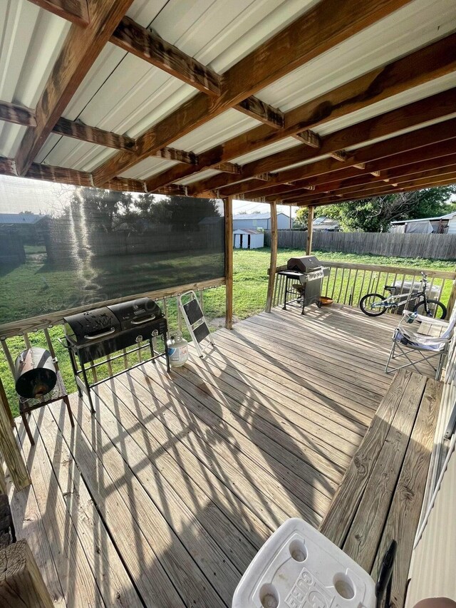 wooden terrace featuring a yard and grilling area