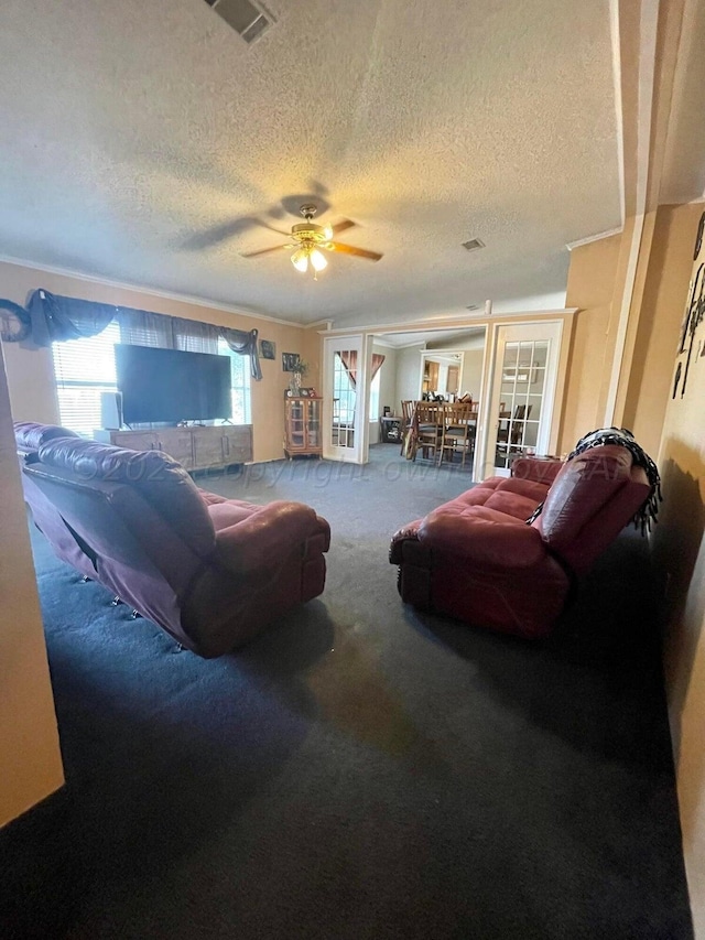 living room featuring ceiling fan, a textured ceiling, and carpet flooring