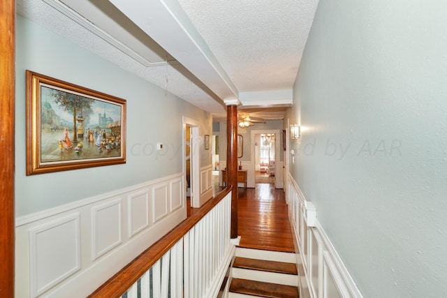 hall with a textured ceiling