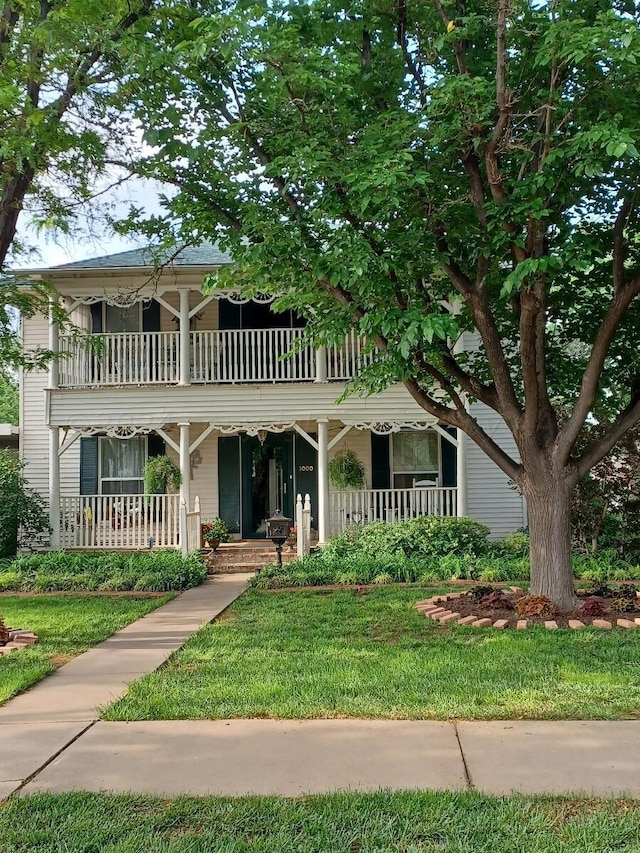 view of front of property featuring covered porch and a balcony