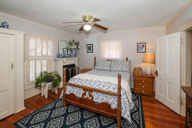 bedroom with ceiling fan, dark hardwood / wood-style flooring, ornamental molding, and multiple windows