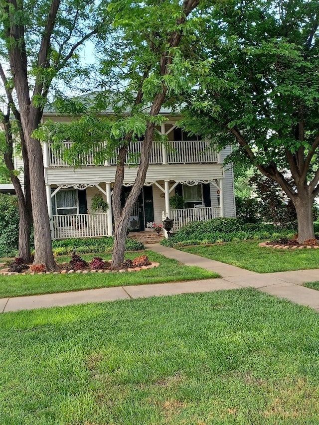 view of front of property with a front yard and a porch