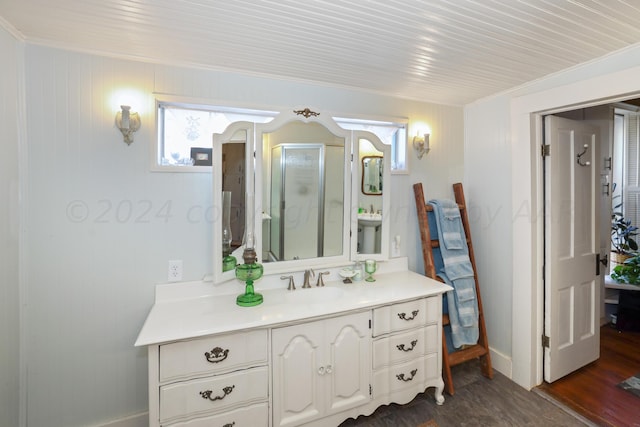 bathroom with crown molding, vanity, a shower with shower door, and hardwood / wood-style flooring