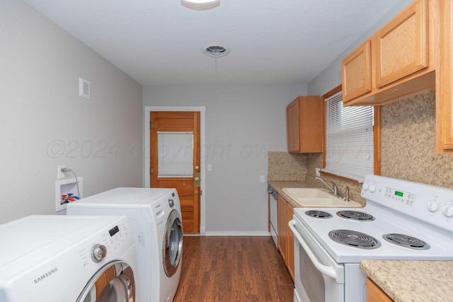 washroom with dark hardwood / wood-style flooring, separate washer and dryer, and sink