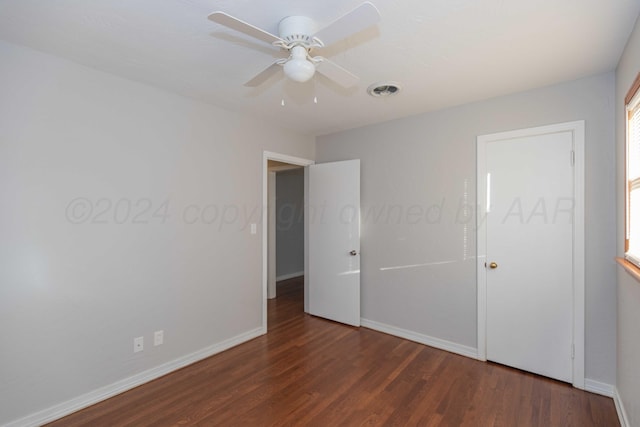 unfurnished bedroom with ceiling fan and dark hardwood / wood-style flooring