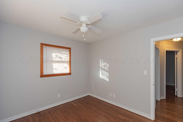 empty room featuring ceiling fan and dark hardwood / wood-style flooring