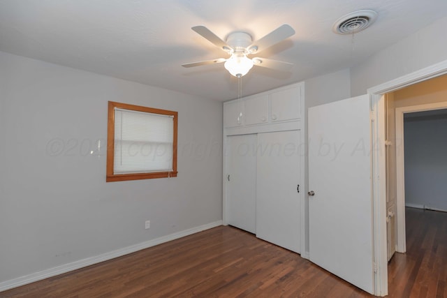 unfurnished bedroom featuring a closet, ceiling fan, and dark wood-type flooring