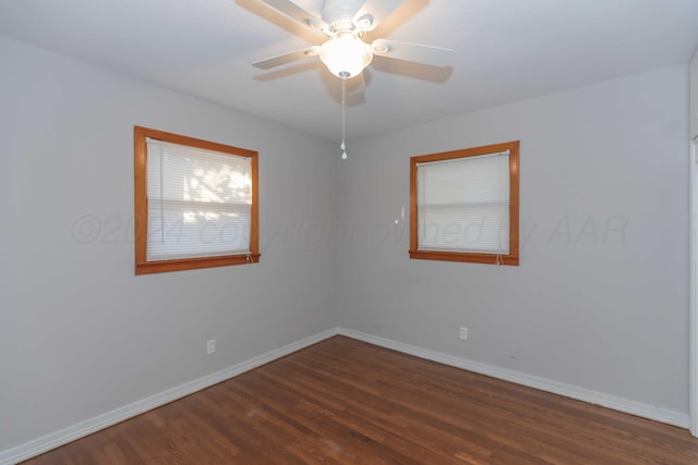 empty room with ceiling fan and dark hardwood / wood-style floors