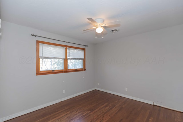 empty room featuring ceiling fan and dark hardwood / wood-style flooring