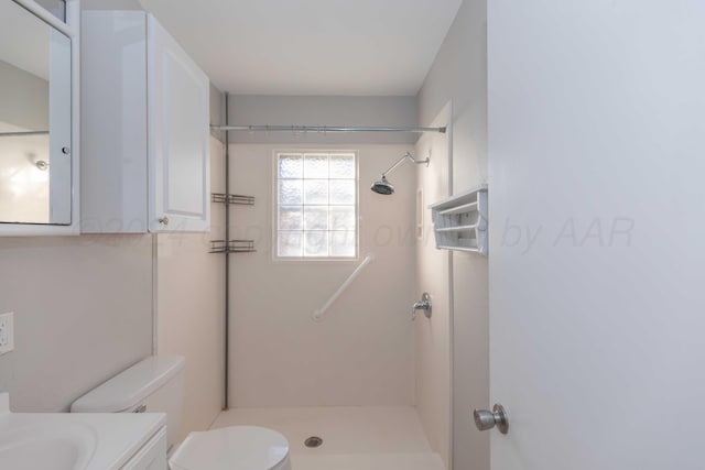 bathroom featuring vanity, toilet, and a shower